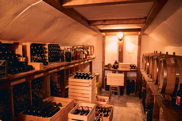 Storage room with wine in bottles and barrels.