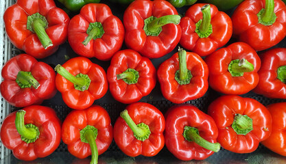 stack of fresh red bell pepper in supermarket.