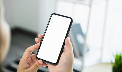 Woman hand holding smartphone and touching blank screen. Mockup of advertisement.