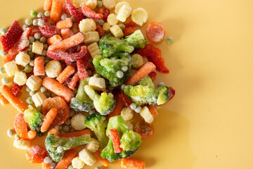Mix of frozen vegetables: paprika, carrot, broccoli, mini corn, tomato and green pea. Copy space. Healthy and vegan food.