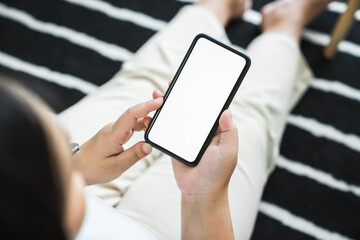Woman hand holding smartphone and touching blank screen. Mockup of advertisement.
