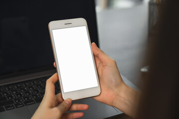 Woman hand holding smartphone and touching blank screen. Mockup of advertisement.