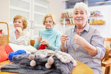 Three senior women crocheting and knitting