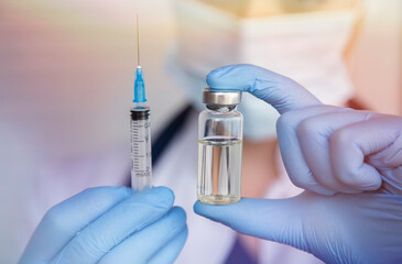 doctor is holding syringe and vaccine for vaccination