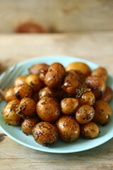 Selective focus. Macro. Fried potatoes in their skins on a plate. Rustic potatoes.