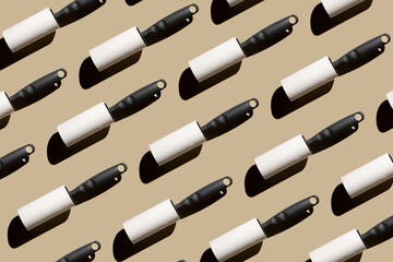 Pattern of rollers for cleaning clothes on a pastel beige background. Cleanliness concept