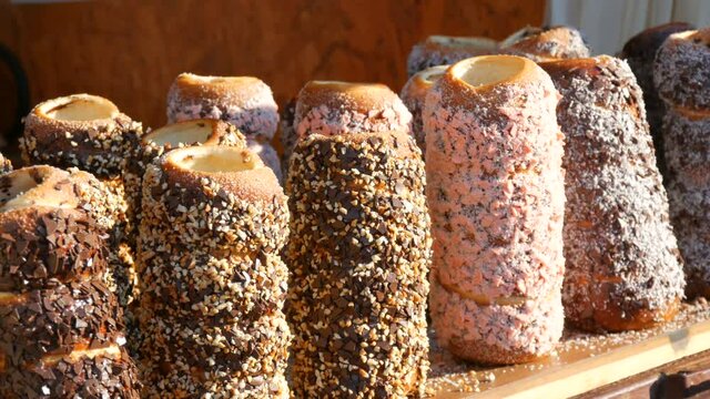 Czech national pastry Trdelnik bun with various sprinkles at the street food festival.