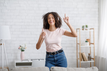 Time to relax. Handsome young woman in headphones sing song and dancing