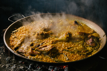 cooking a paella over a wood fire. Valencia Spain