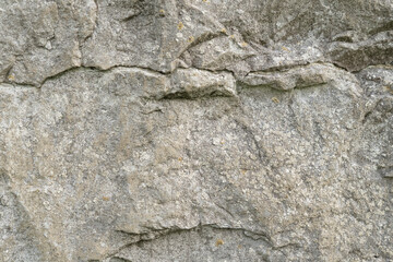 Grungy cracked stone texture from natural rock retro style. Weathered ancient wall background