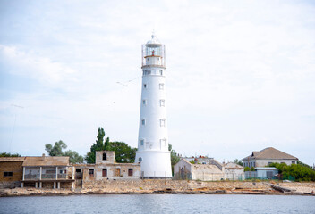 Fototapeta na wymiar View of the old lighthouse from the sea.