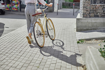 Image of woman enjoying warm autumn weather while going to the job