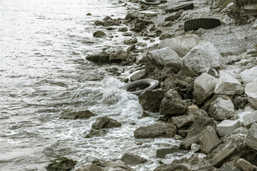 Used car tires remained in nature. The old unnecessary tire of car remained in the water. The problem of recycling waste, garbage, environmental pollution The environmental problem of waste management