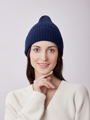 Beautiful woman in autumn hat on a white background. Autumn warm clothes