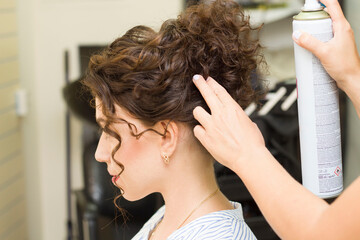 girl gets her hair done in a beauty salon