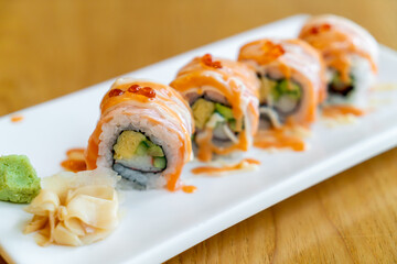 salmon roll sushi with sauce on top
