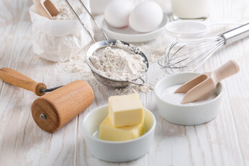 Obraz na płótnie Canvas Spelt flour, sugar with baking ingredients and kitchen utensils