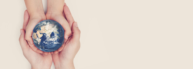 Earth globe in family hands. World safety