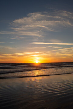 Sunset in the long beach of Zahara de los Atunes marking the horizon line in the Atlantic Ocean, Cadiz, Spain