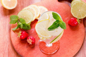 Glass of sparkling lemonade with mint and ice.
