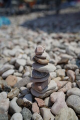 Fototapeta na wymiar Small stones staked as a tower at a lake