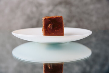 Chocolate cake cut on a mirror surface