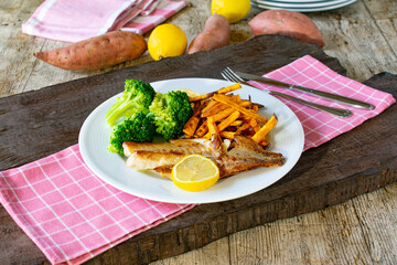 Fish with sweet potatoes fries and broccoli