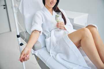 Woman with a pleased smile during the intravenous therapy