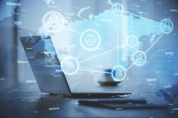 Computer on desktop with social network hologram. Double exposure. Concept of international people connections.