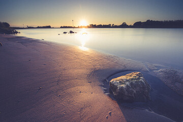 Sunset on the banks of a dutch river, Smooth water surface of a Dutch river at dawn