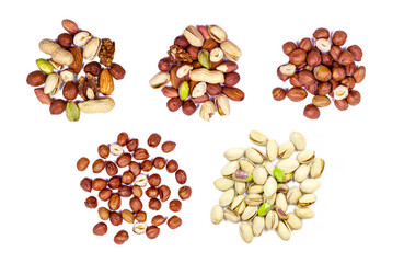 Top view of different nuts mix: almonds, pistachios, peanuts, hazelnuts heap set isolated on white background.