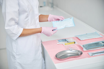 Female dermatologist preparing for performing a medical procedure