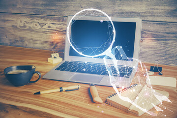 Desktop computer background in office and start up theme hologram drawing. Double exposure. Startup concept.