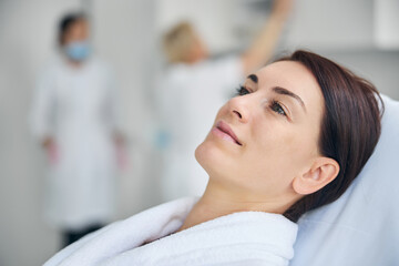 Pleased dreamy female patient in a wellness center