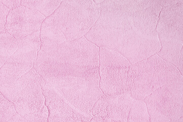 Pink wall of the building. Rough plaster surface. Abstract background.