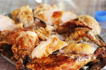 Rotisserie Chicken. Charcoal grilled chicken on the grill. Roast chicken on a divider. Served chicken.