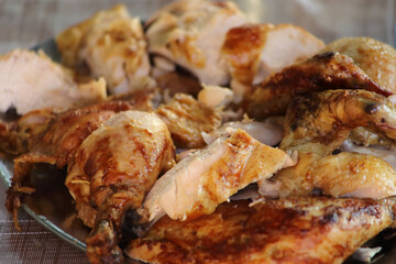 Rotisserie Chicken. Charcoal grilled chicken on the grill. Roast chicken on a divider. Served chicken.