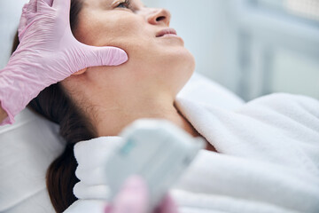 Naklejka premium Calm patient being treated by a professional dermatologist