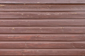 wooden board of horizontal planks weathered and painted in brown