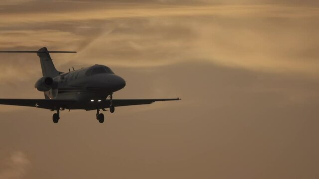 Business jet (private jet) landing in a strong (stiff) wind at sunset