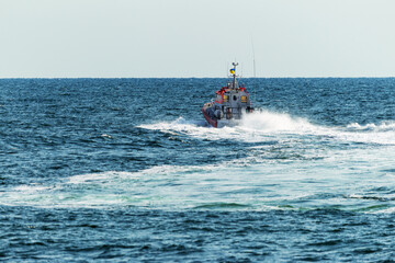 A rescue boat in the sea monitors the safety of tourists on the water and stops violators of order...