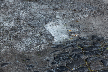 Broken pavements sidewalks on the sidewalk. pavement with paving slabs with defects and cracks going in perspective. The road from the stone, which begins to sink, and created a depression