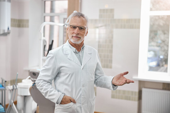 Qualified dentist welcoming everyone to his clinic