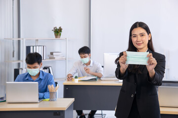 lady in formal dress show surgical  mask in office - prevention in pandemic era concept