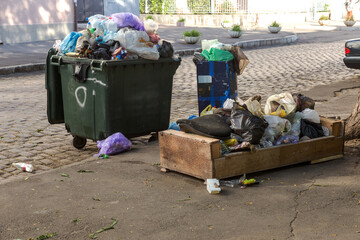 Pile of garbage with garbage bags full of garbage cans on city street. Many household waste plastic...