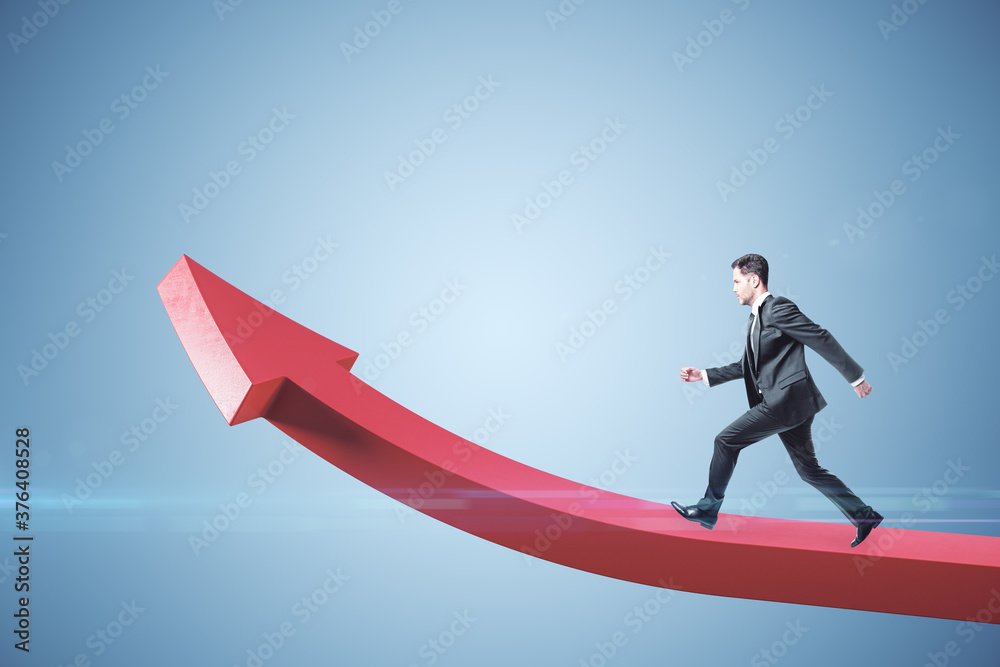 Wall mural businessman runing on red arrow