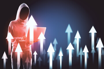 Hacker using laptop with abstract digital arrow hologram