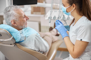 Positive-looking elderly man having a dental appointment