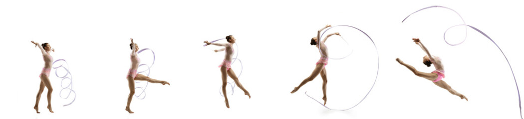 Practice. Little flexible girl isolated on white studio background. Little female rhythmic...