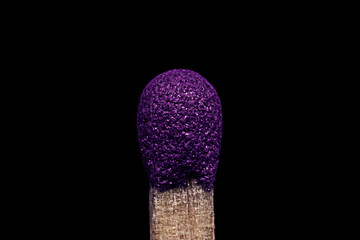 Match head close-up. Unlit match on black background. Macro photography.